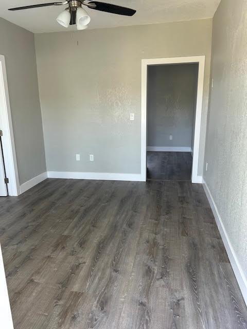 An empty room with gray walls, wood-look flooring, a ceiling fan, and a doorway — 514 S K Street, FL 33460, FL