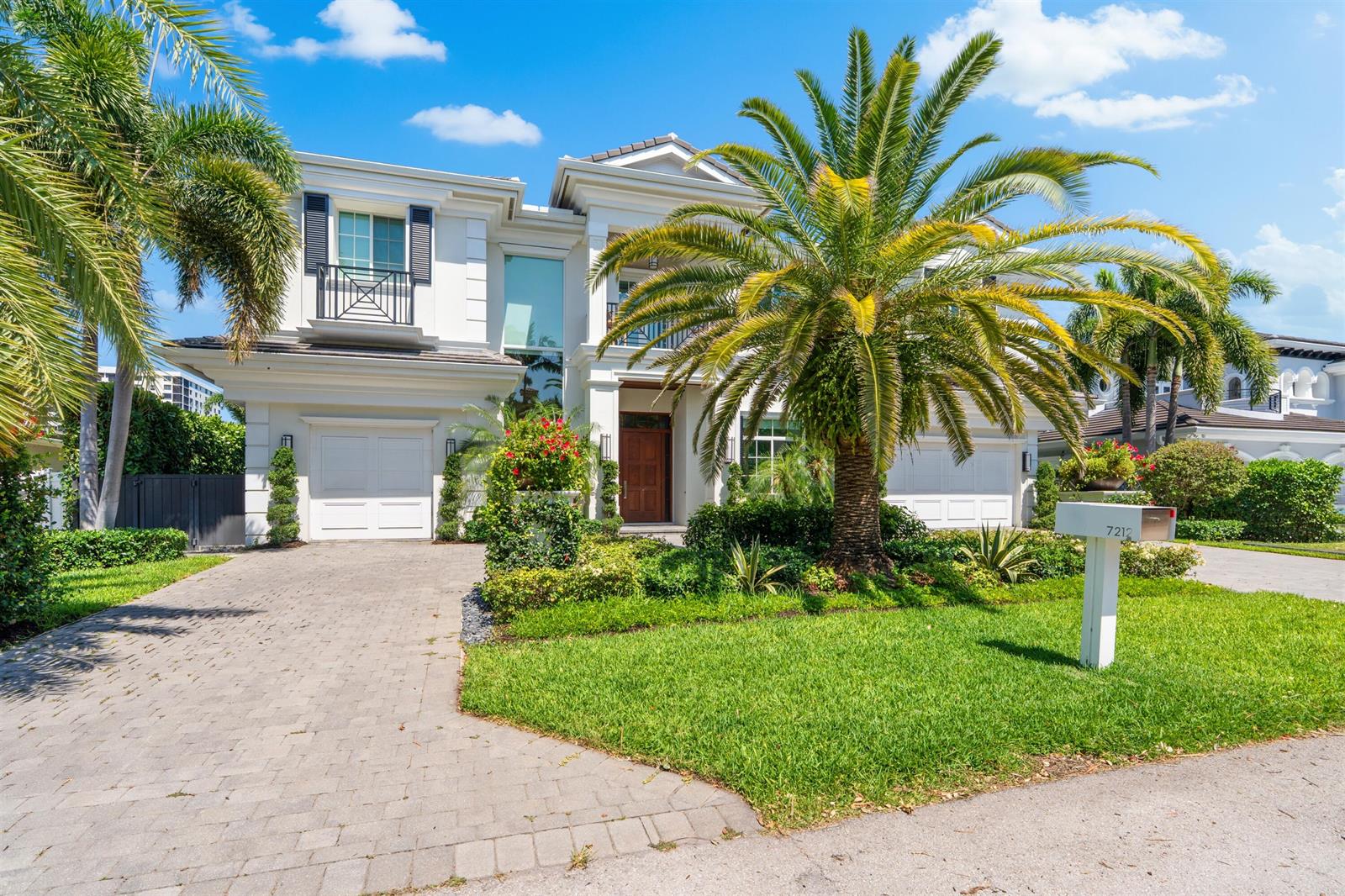 A two-story white house with a palm tree in the front yard and a driveway — 7212 NE 8th Drive, Boca Raton FL 33487, BOCA RATON, FL