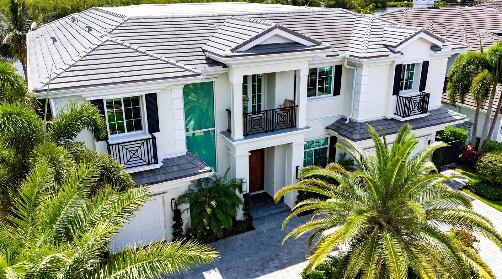 An aerial view of a two-story white house with a gray tiled roof and palms — 7212 NE 8th Drive, Boca Raton FL 33487, BOCA RATON, FL