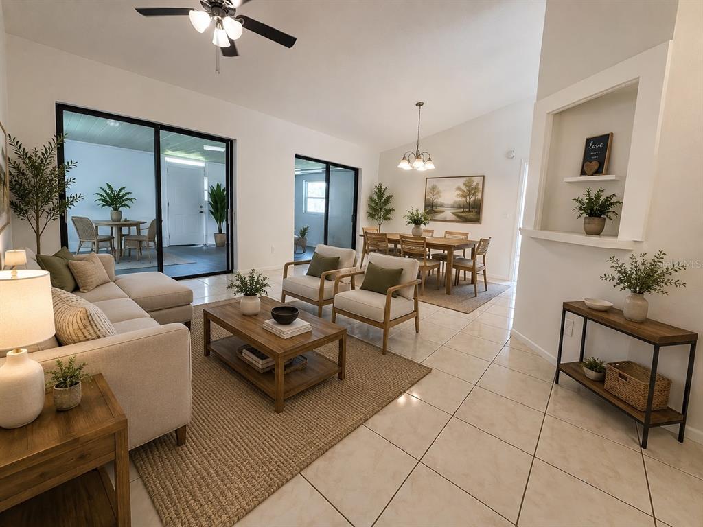 A bright living and dining area features tile floors, neutral furniture, and sliding glass doors — 340 CHIQUITA COURT, KISSIMMEE, FL