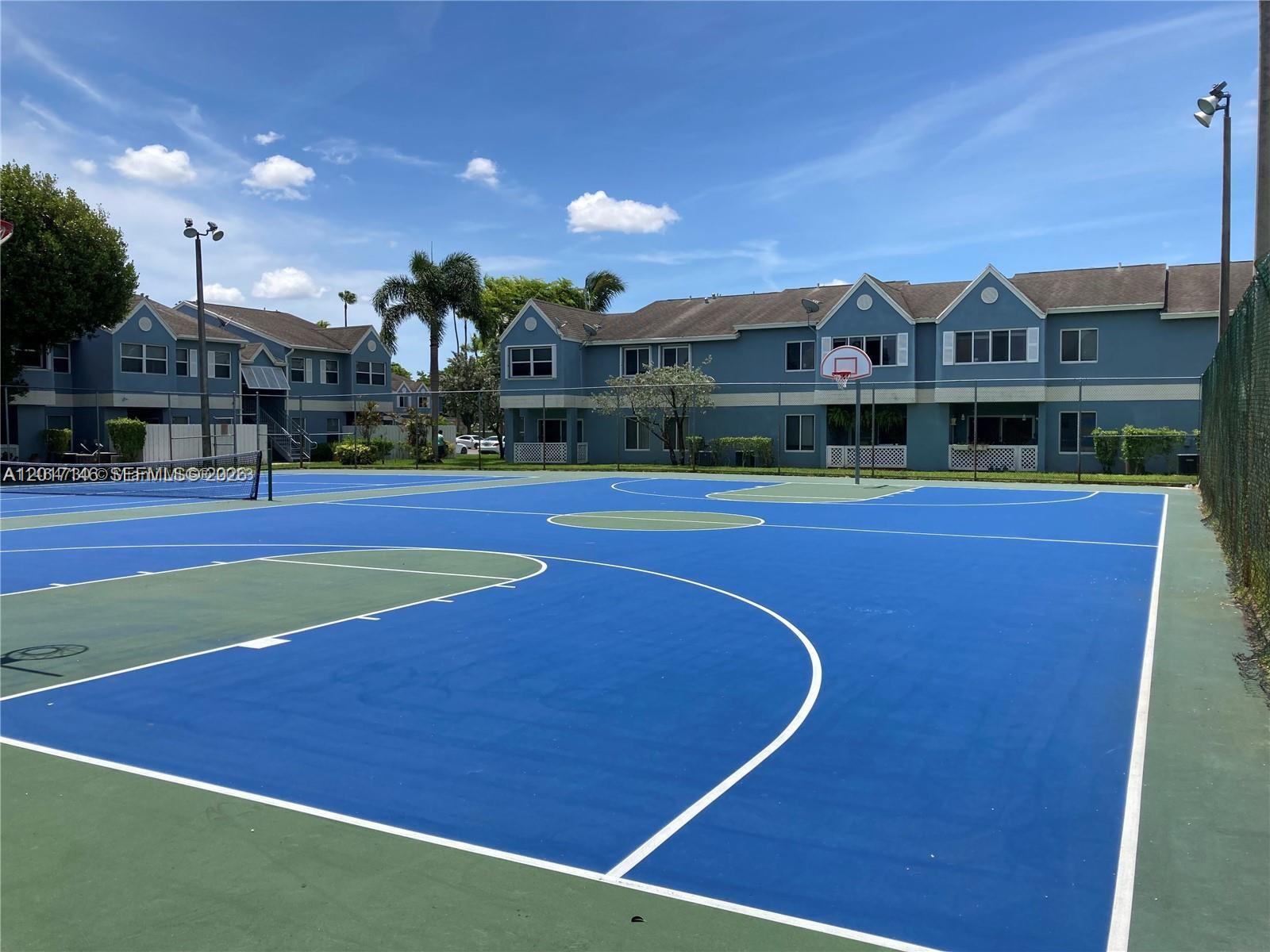 A blue and green outdoor basketball court sits in front of two-story apartment buildings — 6725 NW 174th Ter # 12, Hialeah FL 33015, HIALEAH, FL