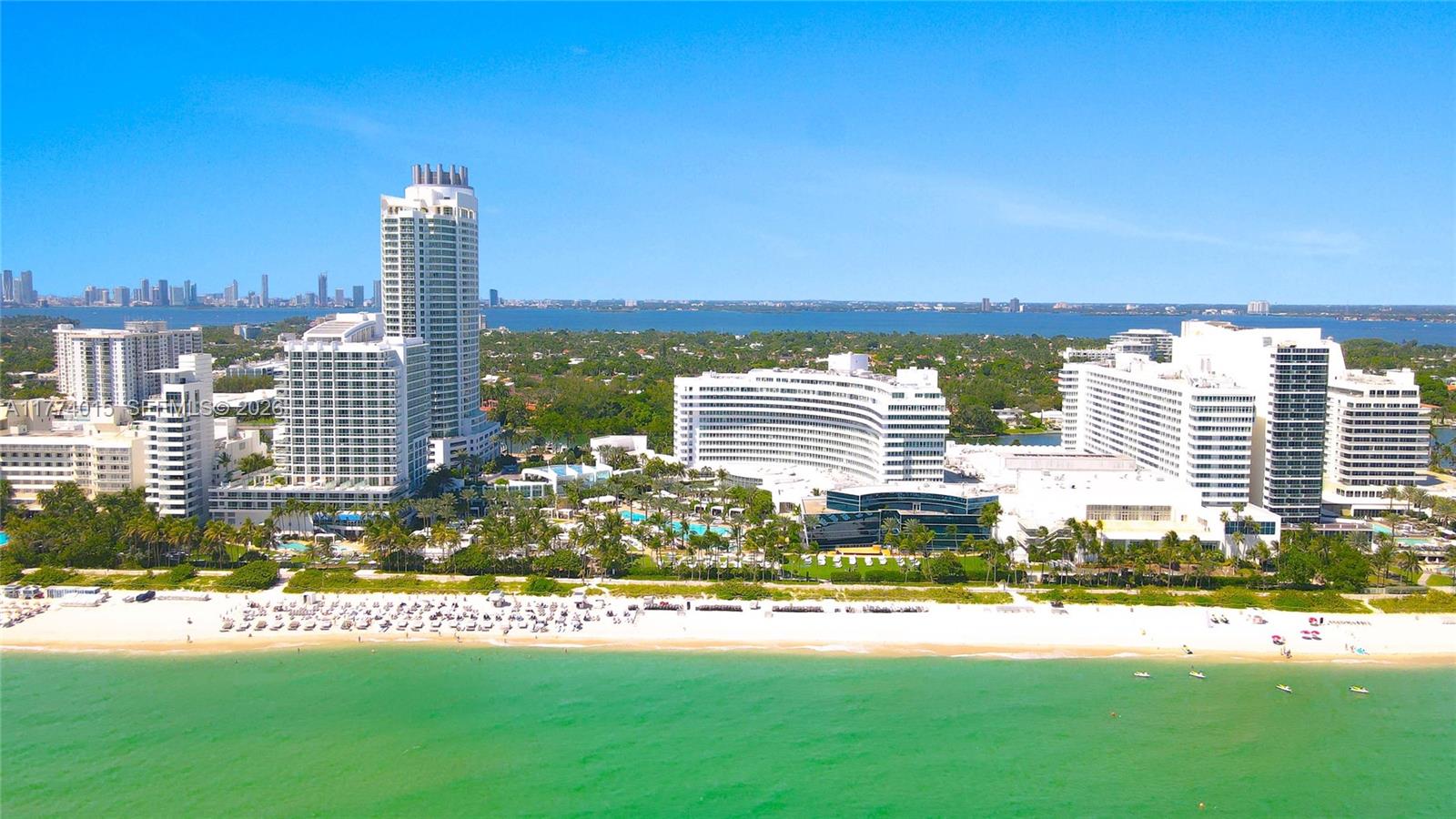 An aerial view of a beachfront resort complex with multiple high-rise buildings and swimming pools — 4391 Collins Ave, Miami Beach FL 33140, MIAMI BEACH, FL
