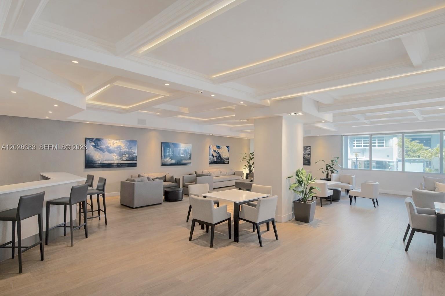 A modern, open-plan lounge features a bar, seating areas, and recessed ceiling lighting — 100 Lincoln Rd # 602, Miami Beach FL 33139, MIAMI BEACH, FL