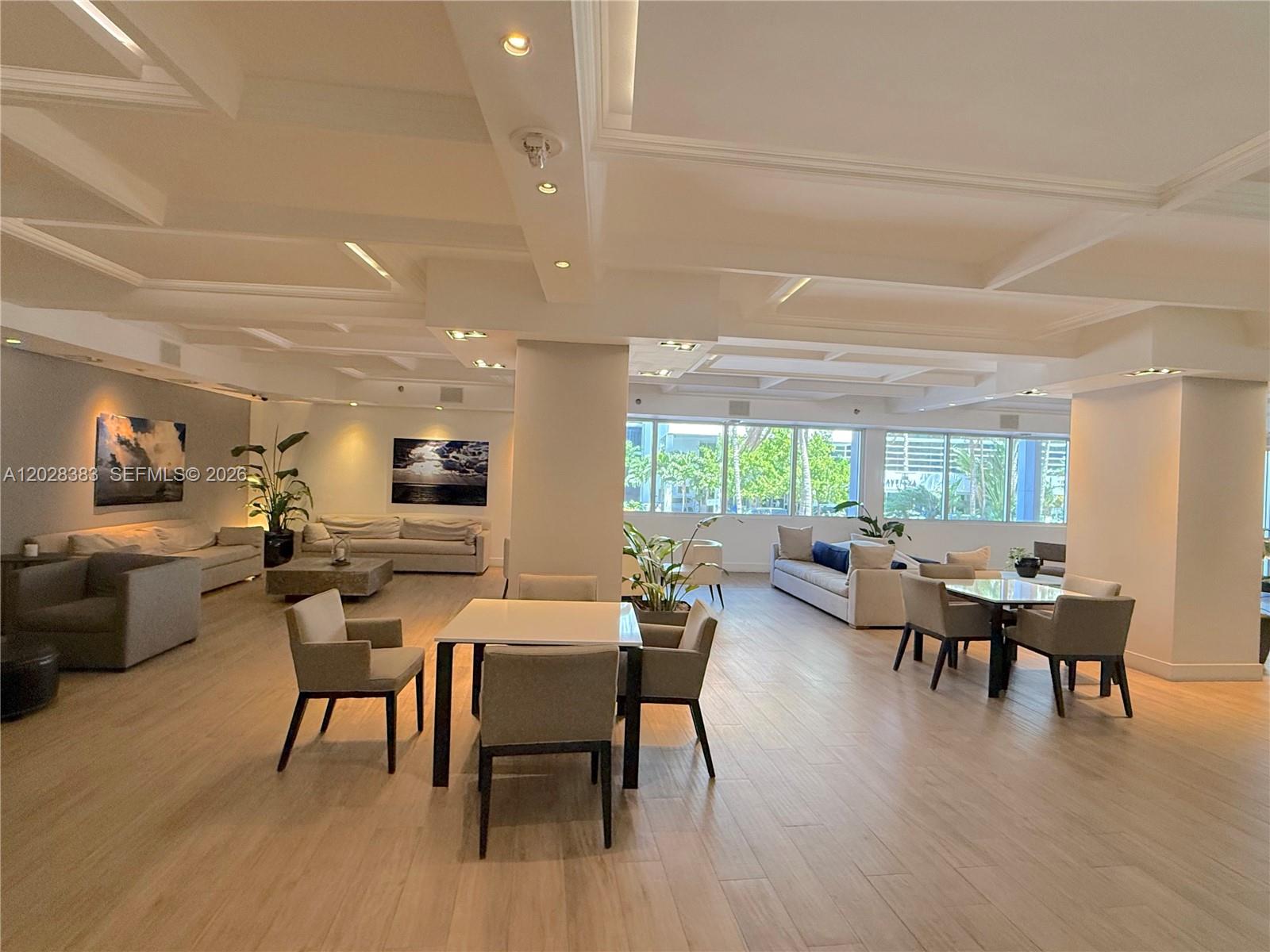 This spacious, open-concept lounge features light wood flooring, recessed ceiling lighting, and multiple seating areas — 100 Lincoln Rd # 602, Miami Beach FL 33139, MIAMI BEACH, FL