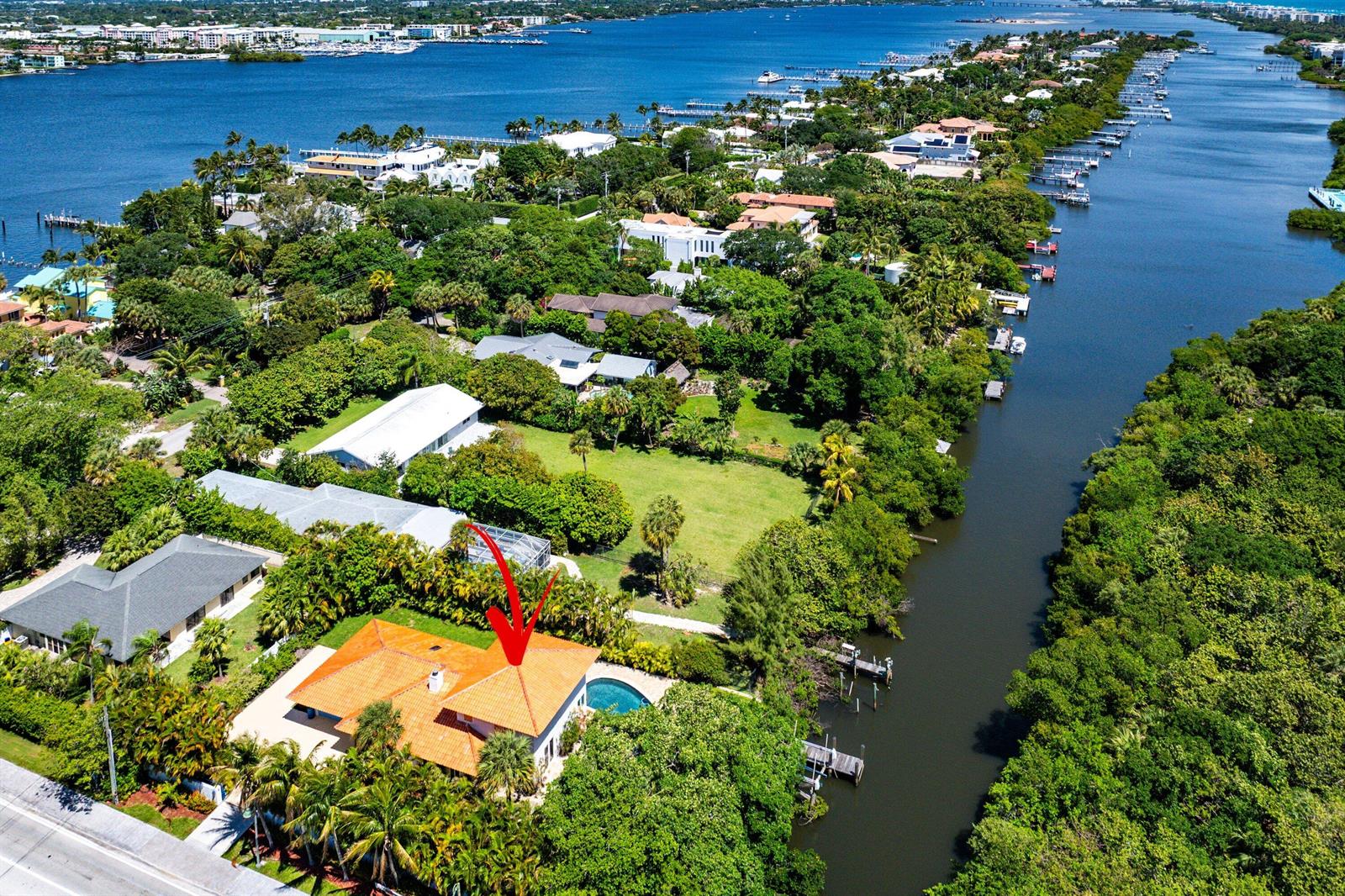 An aerial view of a waterfront house with a red-tiled roof and a swimming pool — 359 E Ocean Avenue, Lantana FL 33462, LANTANA, FL