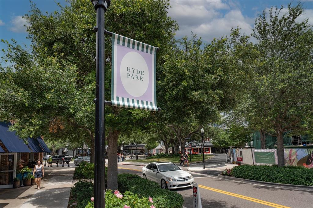A street view of Hyde Park featuring a branded banner, trees, and a white car — 606 S ALBANY AVENUE UNIT 5, TAMPA, FL