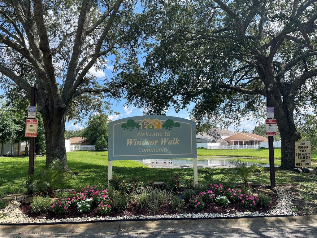 A sign welcomes visitors to the Windsor Walk Community in front of trees and houses — 11020 YORKSHIRE RIDGE COURT, ORLANDO, FL