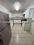A kitchen with white cabinets, stainless steel appliances, and light-colored tile flooring — 8445 Springtree Dr # 202A, Sunrise FL 33351, SUNRISE, FL
