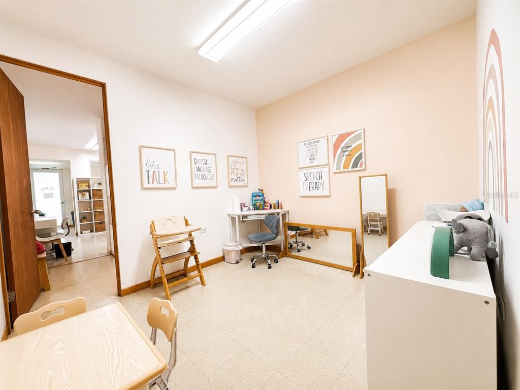A speech therapy office features a wooden high chair, desk, mirrors, and wall art — ACERINA #7 URB. MUÑOZ RIVERA (AVE. MARTINEZ NADAL) UNIT LOCAL A, GUAYNABO, PR