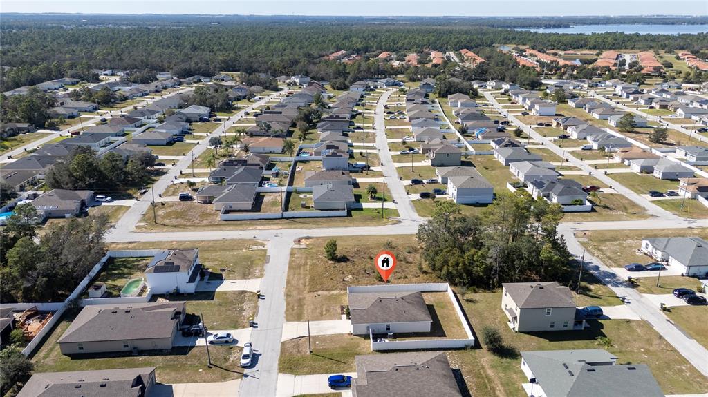 An aerial view shows a suburban neighborhood with a single-family home marked by a pin — 282 FIG COURT, KISSIMMEE, FL