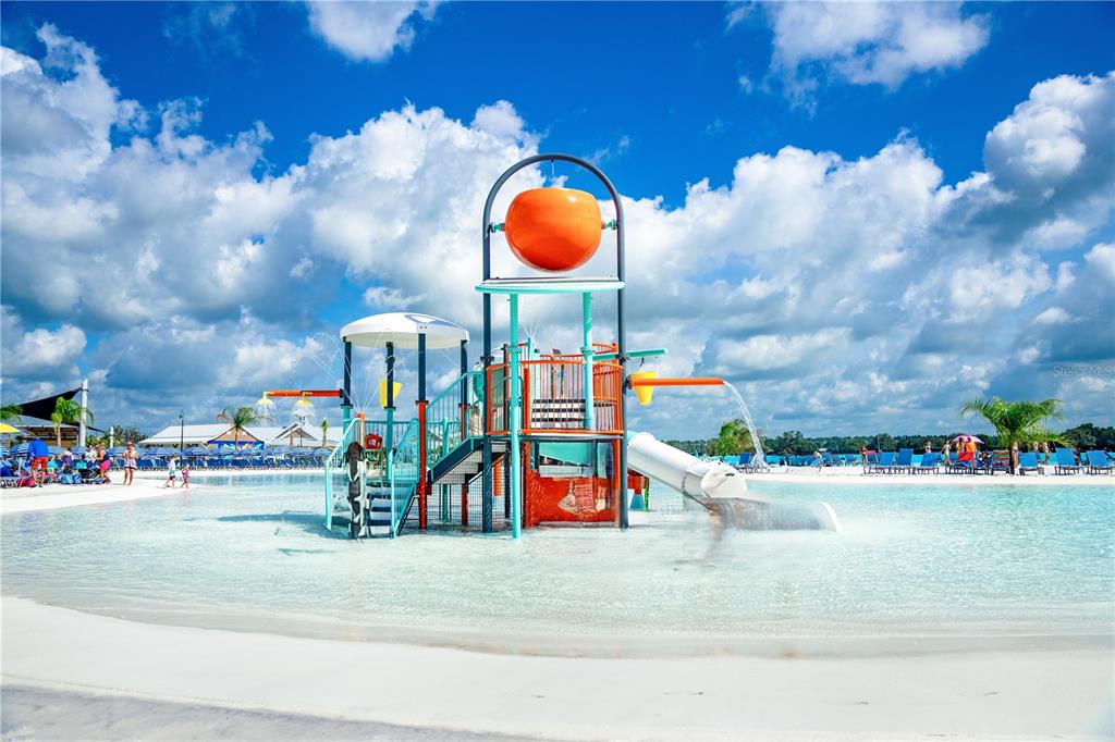 A water park play structure with a large orange bucket sits in a shallow pool — 31665 OCEAN BREEZE DRIVE, SAN ANTONIO, FL