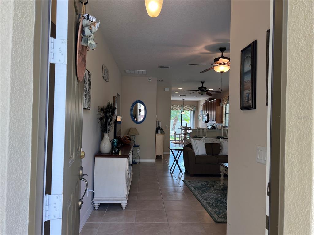An empty room with beige walls, tile flooring, a ceiling fan, and two windows — 2002 FISHTAIL FERN WAY, OCOEE, FL