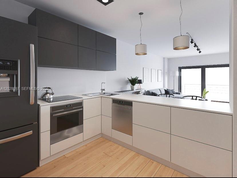 This rendering shows a modern kitchen with dark upper cabinets, light lower cabinets, and appliances — 401 Ocean Dr # 224, Miami Beach FL 33139, MIAMI BEACH, FL