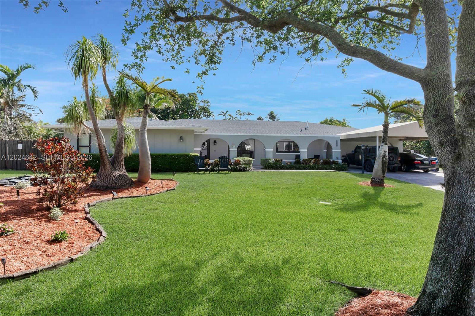 A single-story house with an arched front porch, palm trees, and a large front lawn — 8825 SW 185th Ter, Cutler Bay FL 33157, CUTLER BAY, FL