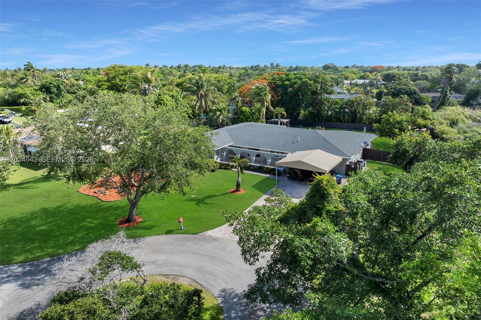 An aerial view shows a single-story house with a carport and a large grassy yard — 8825 SW 185th Ter, Cutler Bay FL 33157, CUTLER BAY, FL