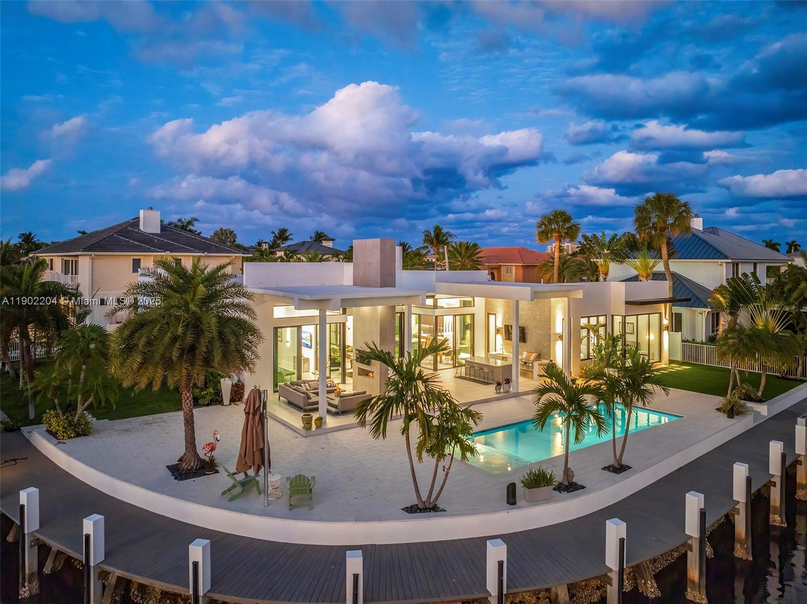 An aerial view of a modern waterfront home featuring a pool, patio, and private dock — 3701 NE 26th Ave # 1, Lighthouse Point FL 33064, LIGHTHOUSE POINT, FL