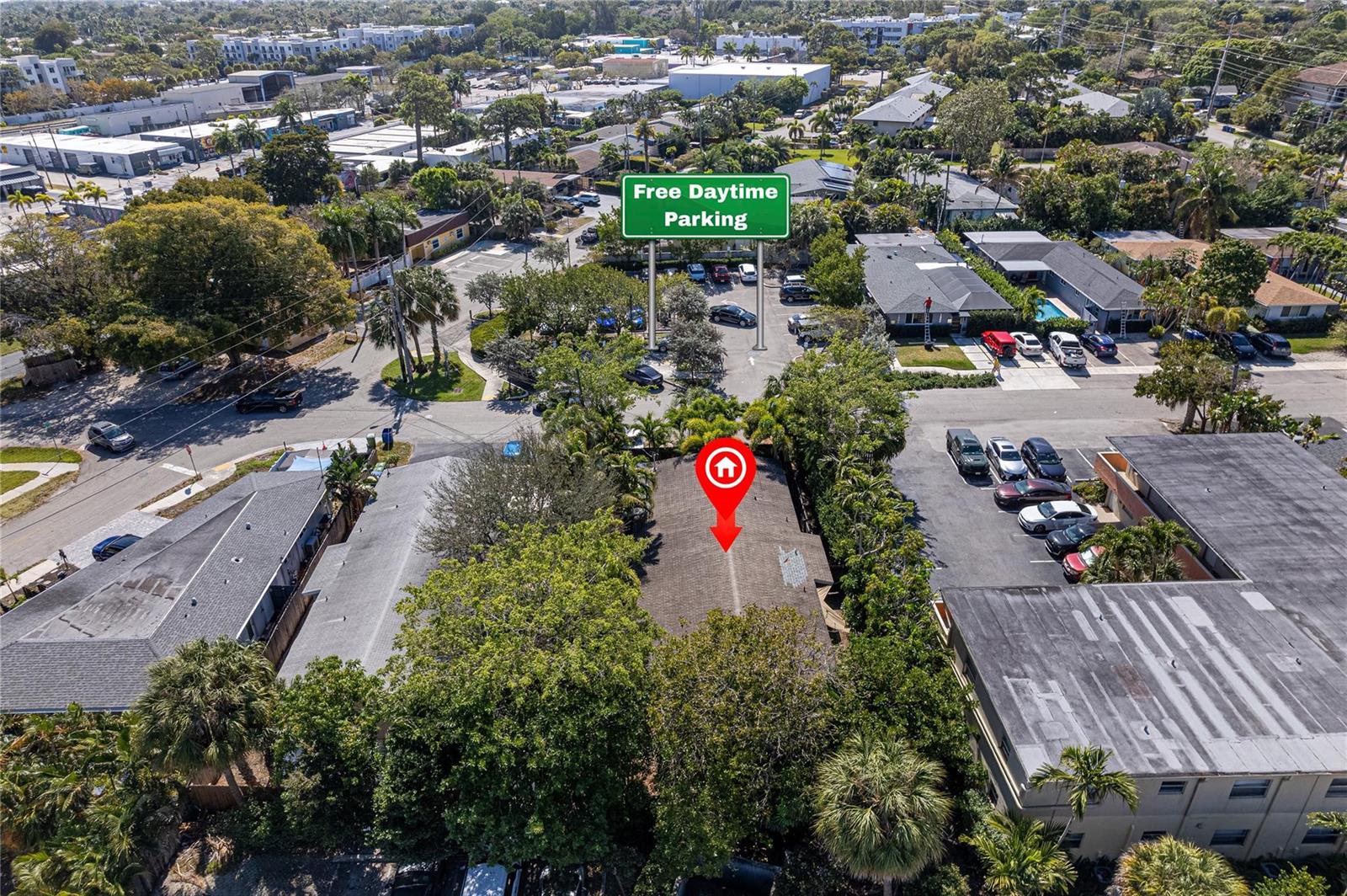 An aerial view shows a residential building surrounded by trees and nearby parking lots — 1009 NE 23rd Drive, Wilton Manors FL 33305, WILTON MANORS, FL