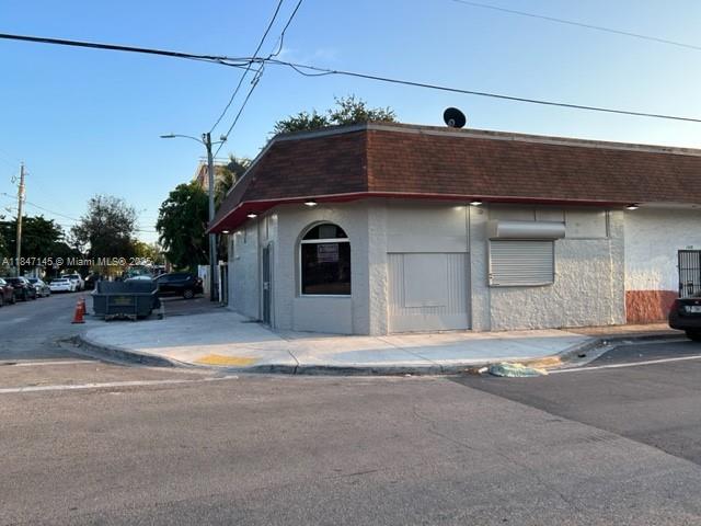 A corner commercial building features a brown shingled roof and a white stucco exterior — 1400 SW 6th St, Miami FL 33135, MIAMI, FL
