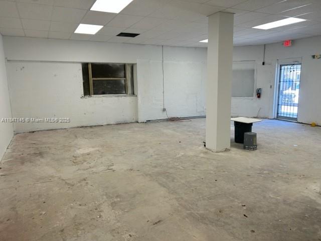 An empty commercial space features white walls, a concrete floor, and a central support pillar — 1400 SW 6th St, Miami FL 33135, MIAMI, FL