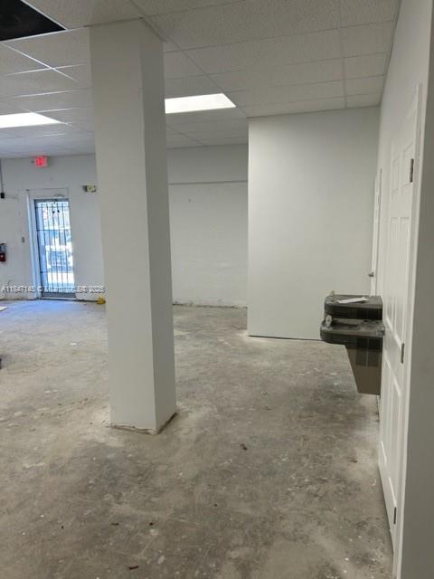 An empty commercial space features a concrete floor, a central support column, and a water fountain — 1400 SW 6th St, Miami FL 33135, MIAMI, FL