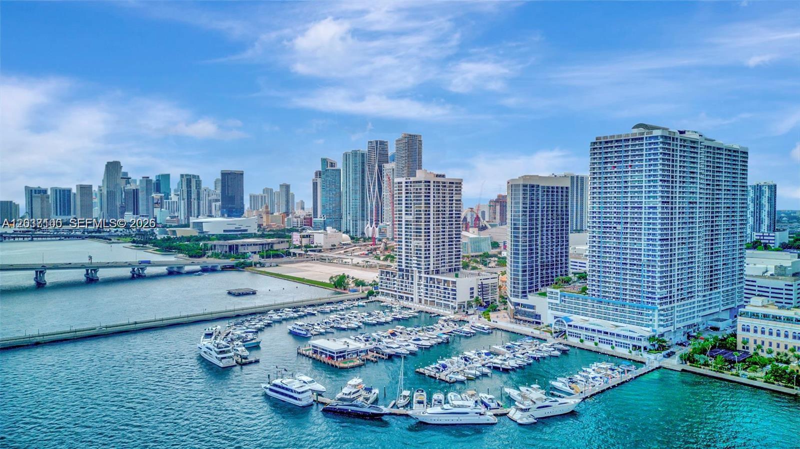 An aerial view of a marina with many boats docked in front of Miami skyscrapers — 555 NE 15th St # 17E, Miami FL 33132, MIAMI, FL