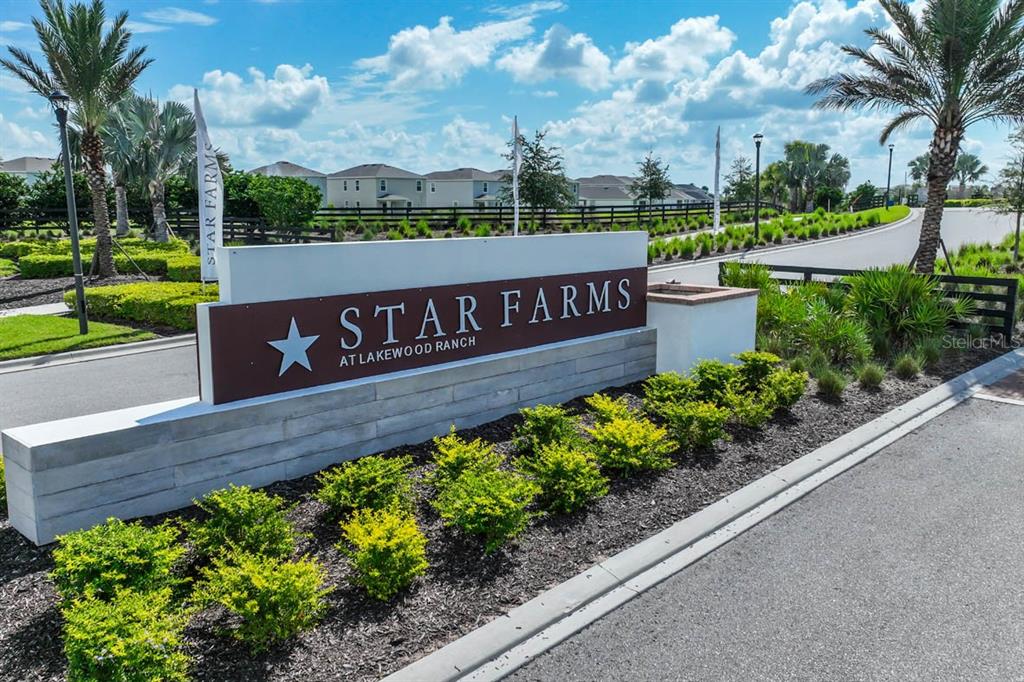 A sign for Star Farms at Lakewood Ranch stands at the entrance of a neighborhood — 16905 YARD SPRING DRIVE, BRADENTON, FL