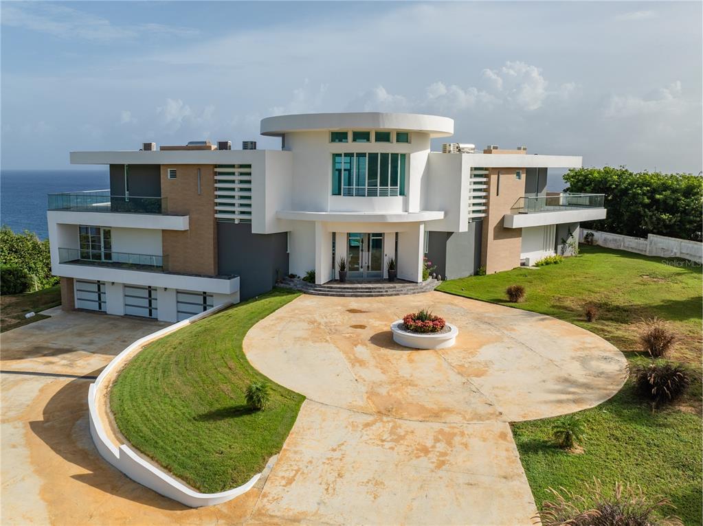 A modern, multi-story white house with a circular central tower and a large concrete driveway — 991 CALLE ESTACION, QUEBRADILLAS, PR