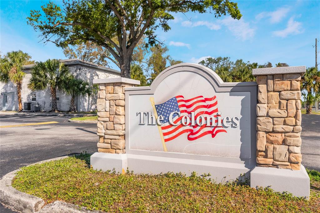 A stone-accented monument sign for The Colonies stands in front of a building and trees — 3071 GEORGE MASON AVENUE UNIT 5, WINTER PARK, FL