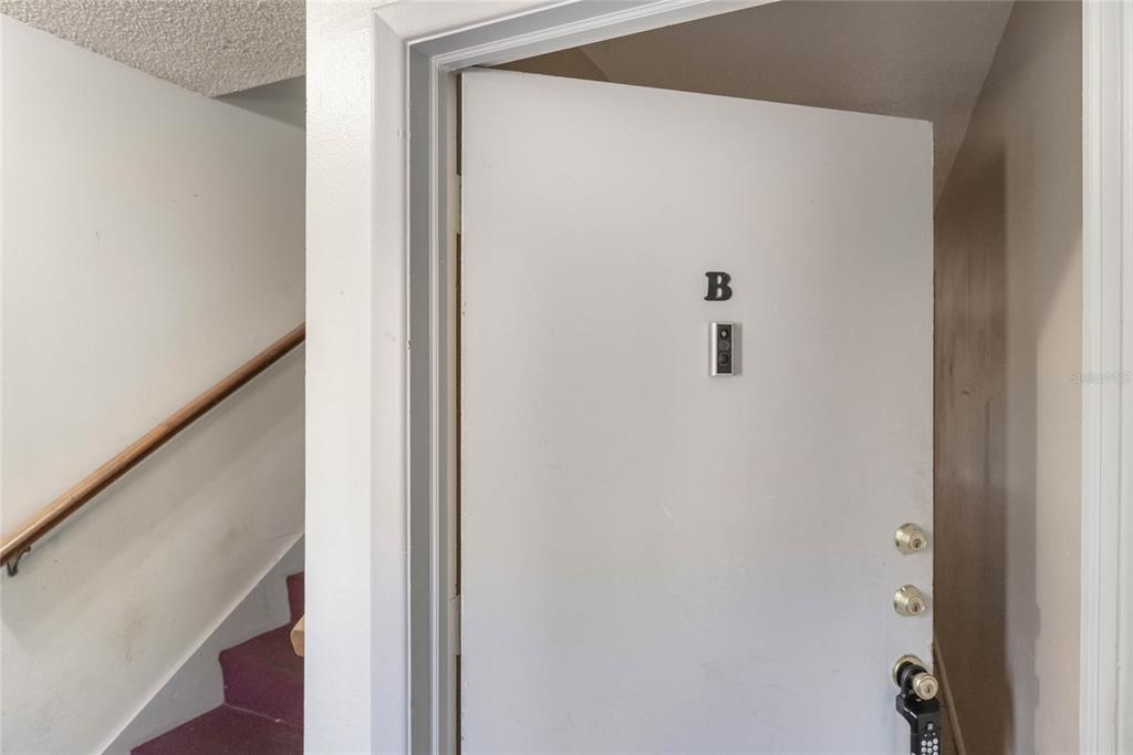 A white door labeled B opens to a staircase with a wooden handrail — 3071 GEORGE MASON AVENUE UNIT 5, WINTER PARK, FL