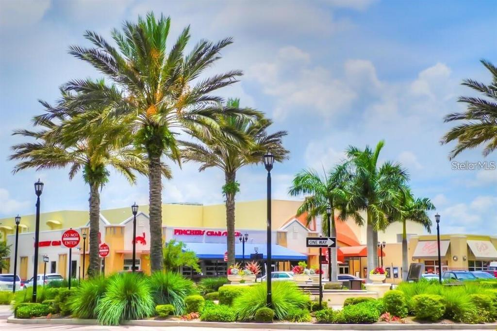 A commercial shopping center exterior features palm trees, landscaping, and a Pinchers Crab Shack restaurant — 8111 LAKEWOOD MAIN STREET UNIT 307, LAKEWOOD RANCH, FL