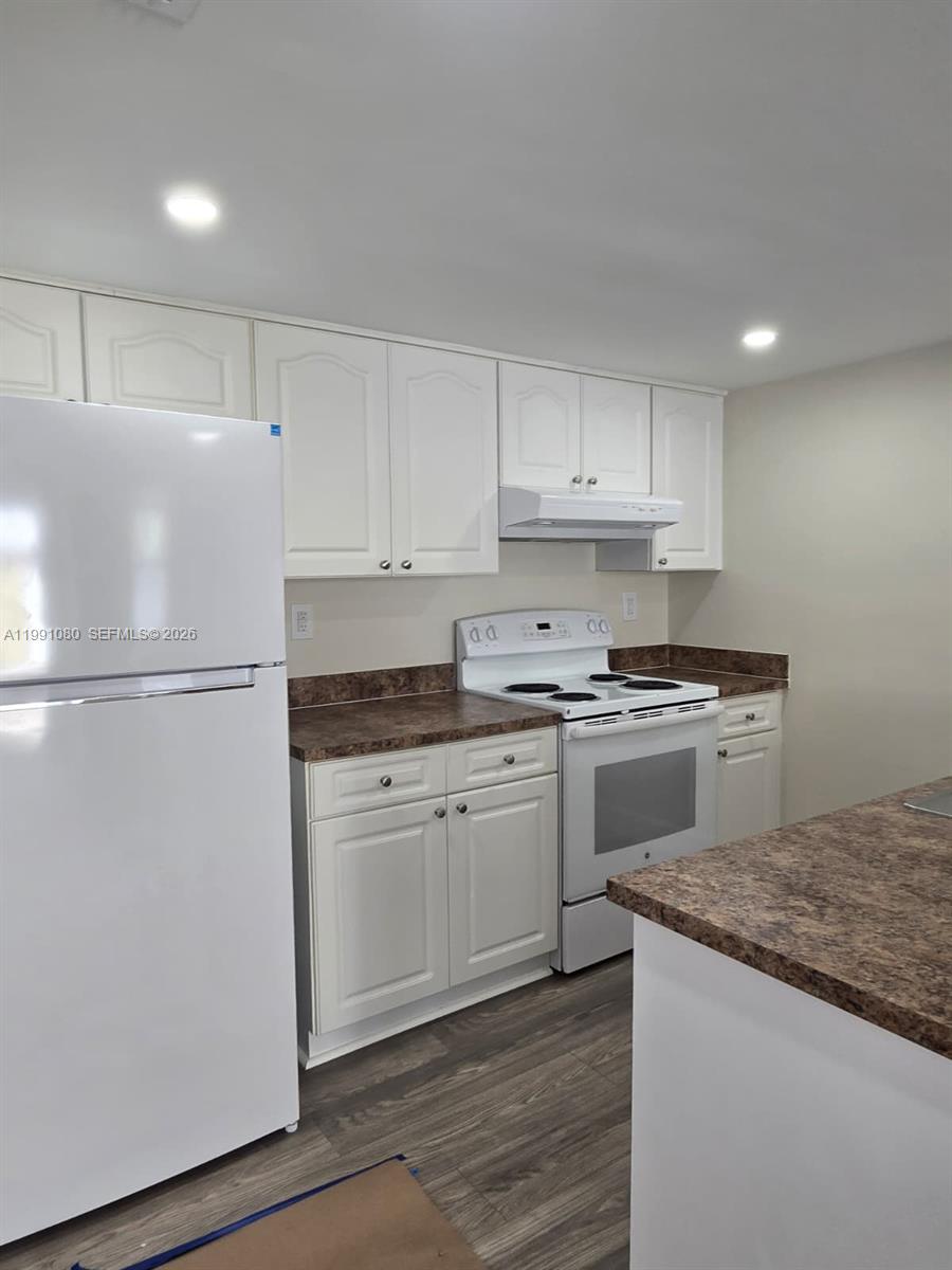 A kitchen features white cabinets, a white refrigerator, a white stove, and brown countertops — 6825 SW 45th Ln # 12, Miami FL 33155, MIAMI, FL