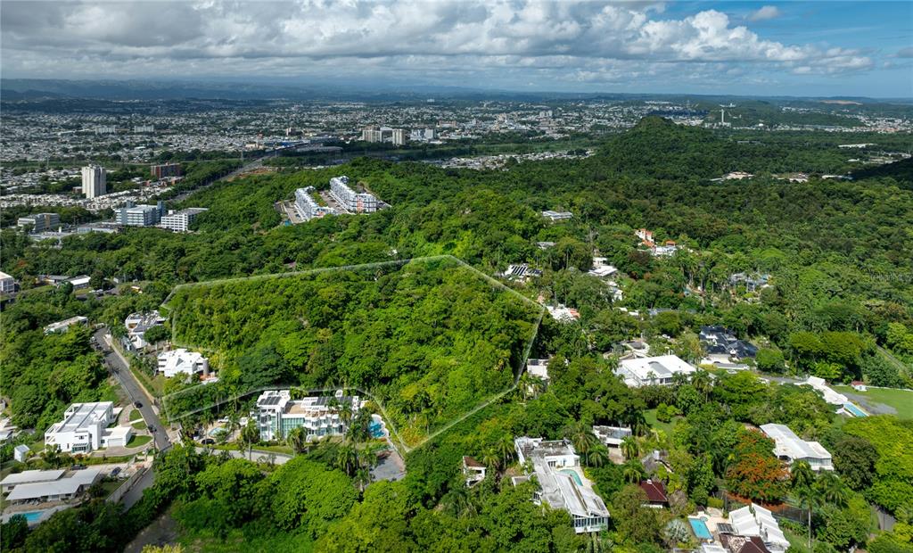 An aerial view shows a large, wooded residential lot outlined in white amidst surrounding homes — Lot E 502 TINTILLO STREET, GUAYNABO, PR