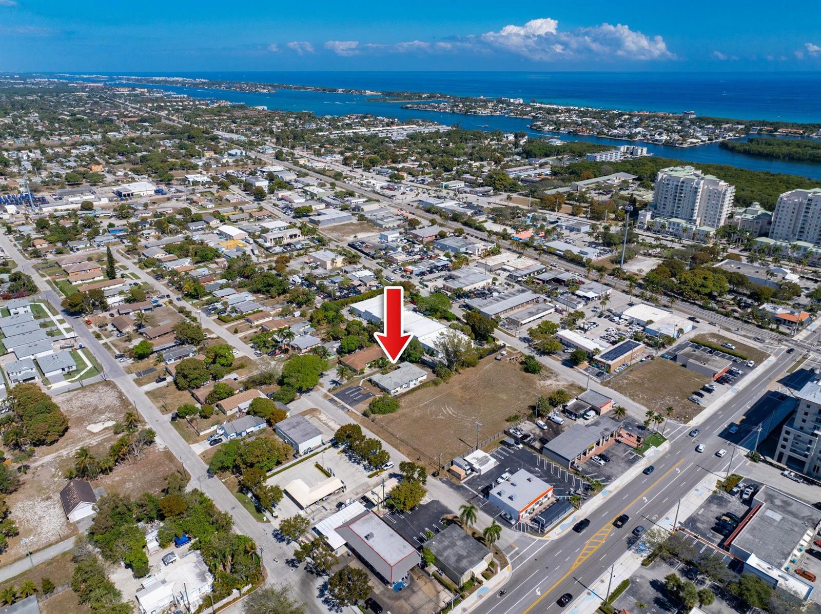 An aerial view shows a residential property marked by a red arrow near commercial buildings — 400 NE 2nd Street, Boynton Beach FL 33435, BOYNTON BEACH, FL
