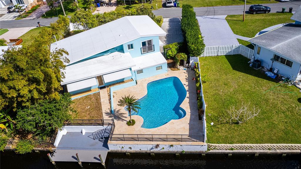 An aerial view of a light blue house with a pool and a private dock — 2631 KEY LARGO LANE, FORT LAUDERDALE, FL