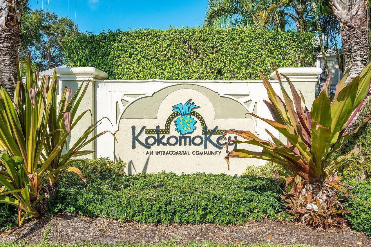 A sign for Kokomo Key, an intracoastal community, stands between two large tropical plants — 834 Kokomo Key Lane, Delray Beach FL 33483, DELRAY BEACH, FL