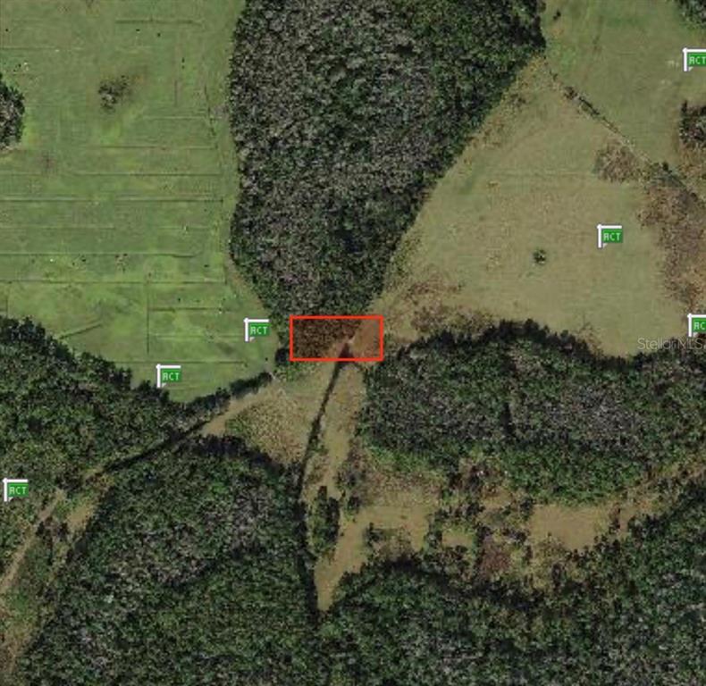 This is an aerial map showing a rectangular plot of land highlighted in red — POLK CITY, POLK CITY, FL