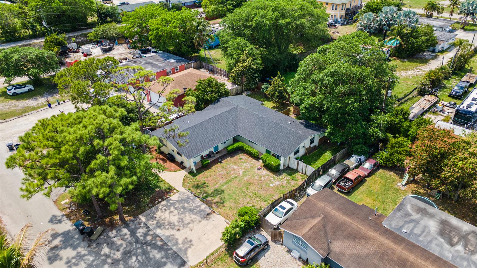 An aerial view shows a single-story L-shaped house with a dark roof and yard — 4453 Stevens Road, FL 33461, FL