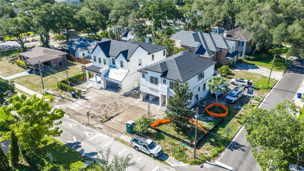 An aerial view shows two newly constructed white houses with black roofs under development — 4020 W CLEVELAND, TAMPA, FL