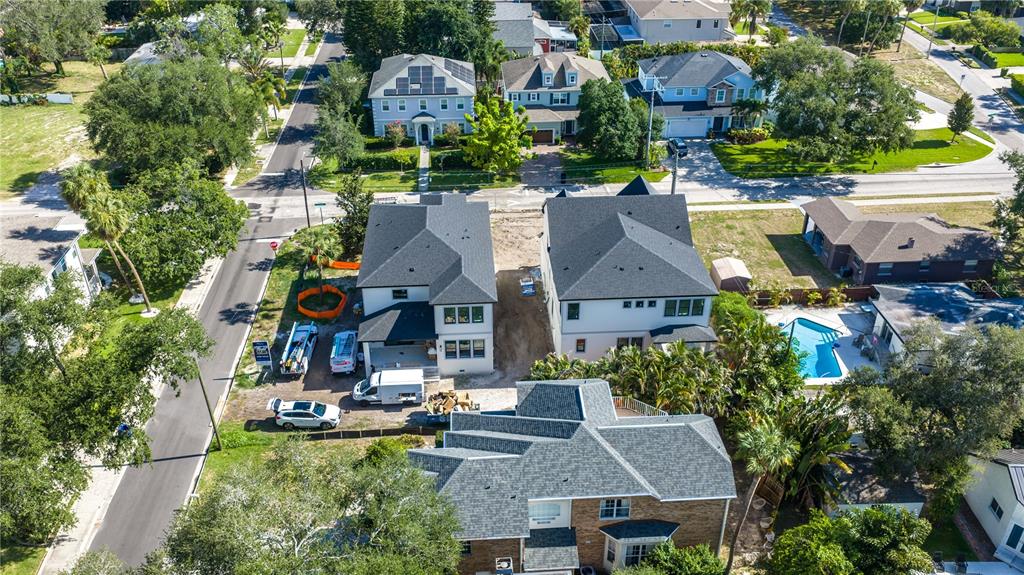 An aerial view shows three houses, including two new builds under construction, in a residential neighborhood — 4020 W CLEVELAND, TAMPA, FL