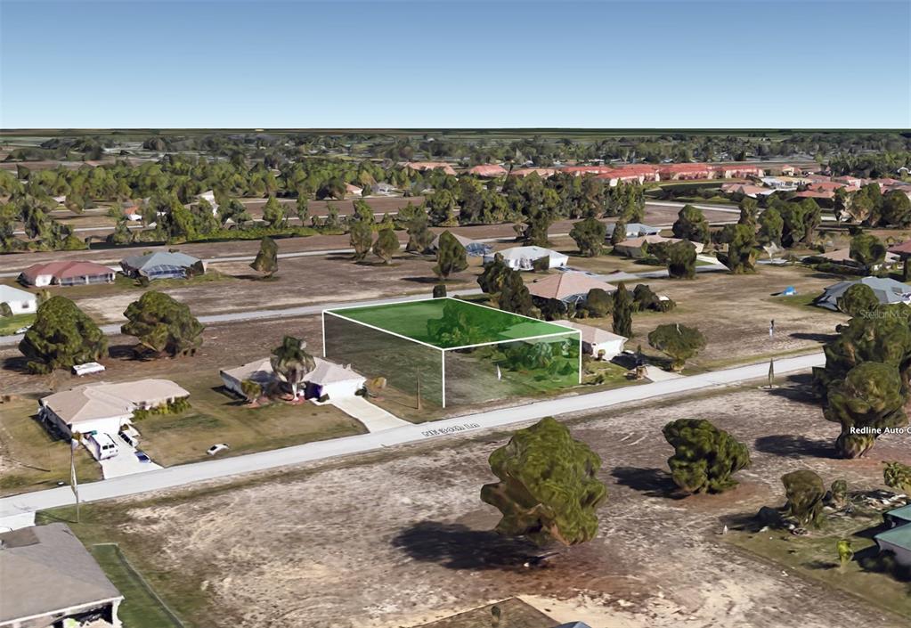 An aerial view shows a vacant, rectangular residential lot highlighted in green along a street — 2215 NE 34TH LN, CAPE CORAL, FL
