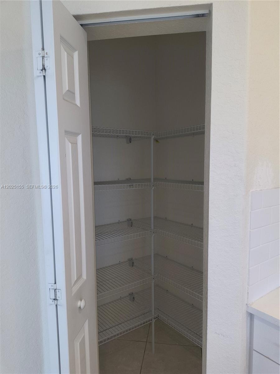 A pantry with white wire shelving and a white door — 1645 SE 20th Rd # 1645, Homestead FL 33035, HOMESTEAD, FL
