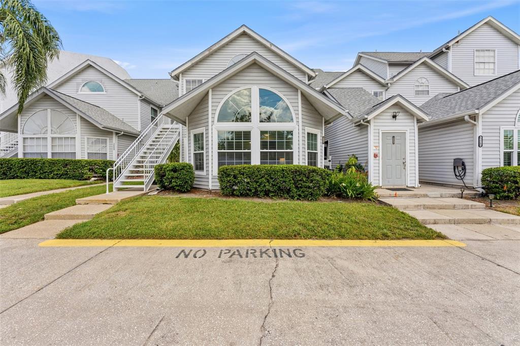 A light gray multi-unit residential building with a concrete driveway marked no parking — 12237 ARMENIA GABLES CIR, TAMPA, FL