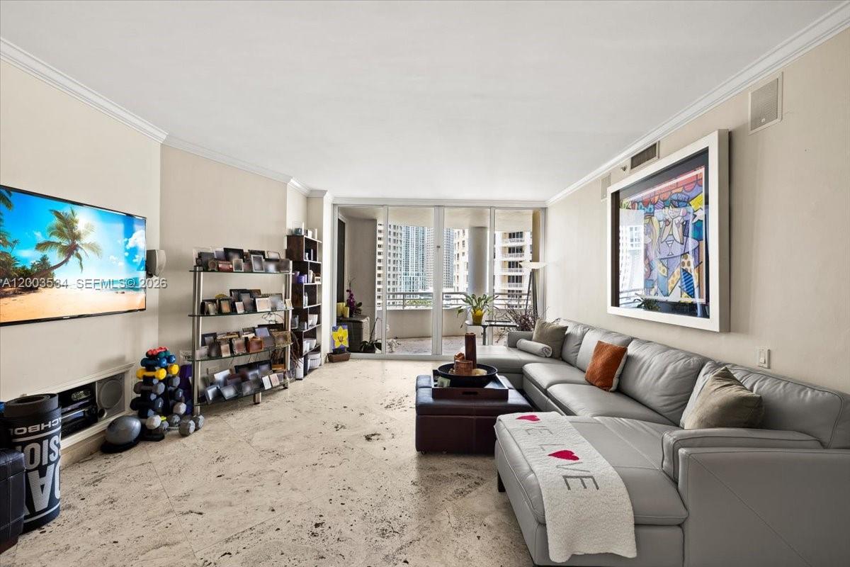 A living room features a gray sectional sofa, a television, and a balcony with views — 808 BRICKELL KEY DR # 1205, Miami FL 33131, MIAMI, FL