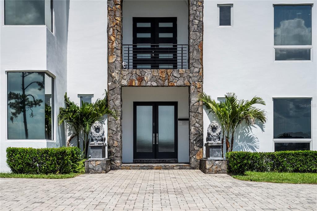 A modern two-story house exterior features a curved glass wall, a pool, and a spa — 736 LAKE WINNEMISSETT DRIVE, DELAND, FL