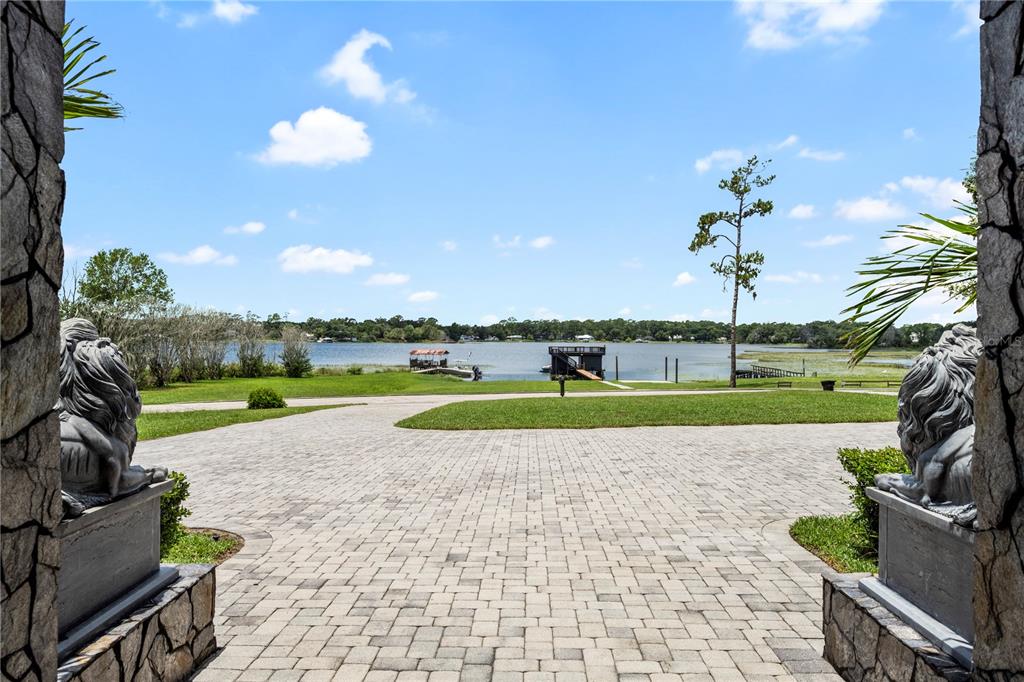 A modern white house exterior features a swimming pool, a hot tub, and a patio — 736 LAKE WINNEMISSETT DRIVE, DELAND, FL
