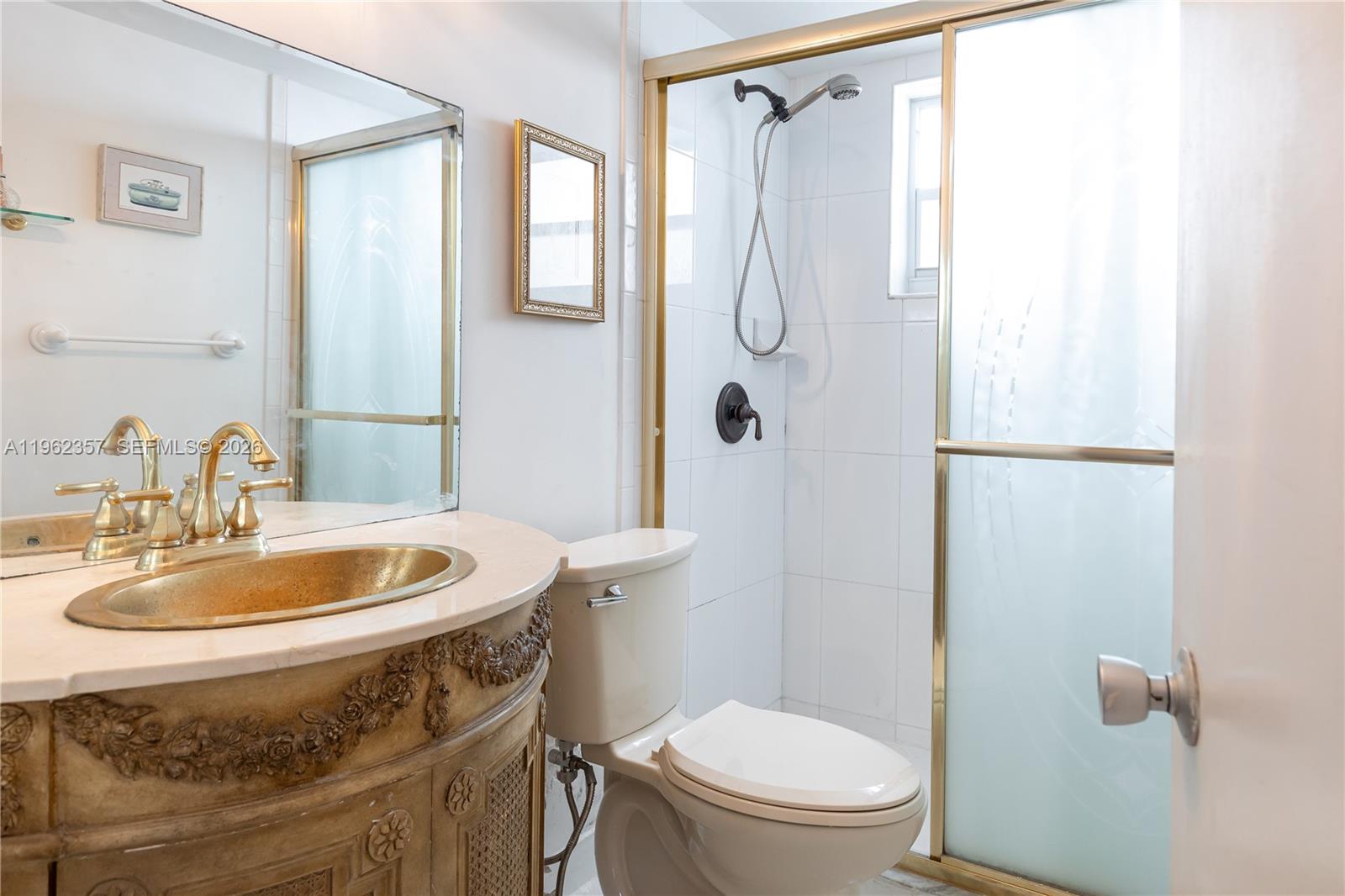 A bathroom features a decorative vanity with a gold sink, a toilet, and a shower — 3127 S Ocean Dr # 219, Hallandale Beach FL 33009, HALLANDALE BEACH, FL