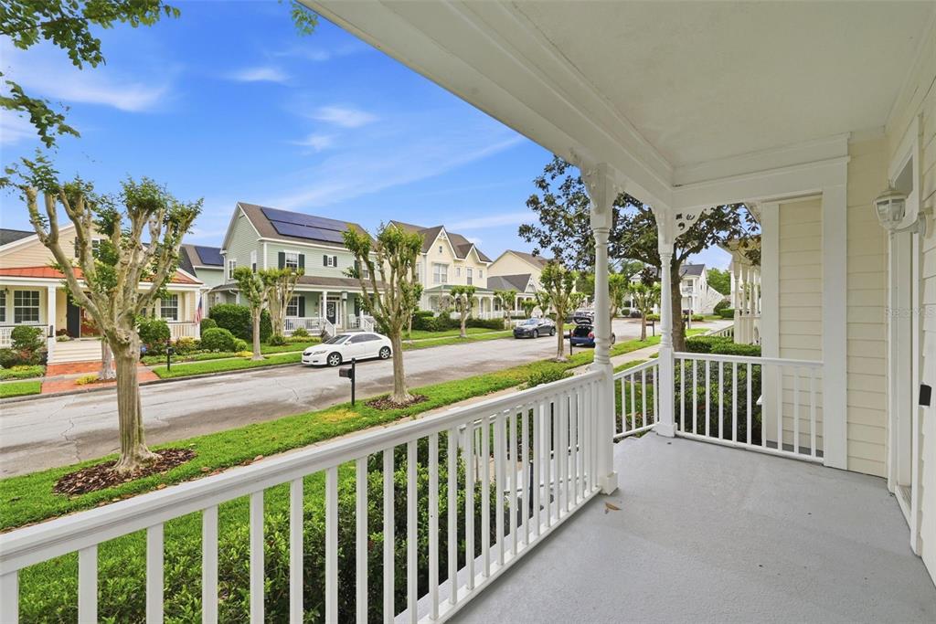 A view from a covered front porch looking out onto a residential street with houses — 1110 RUSH COURT, CELEBRATION, FL