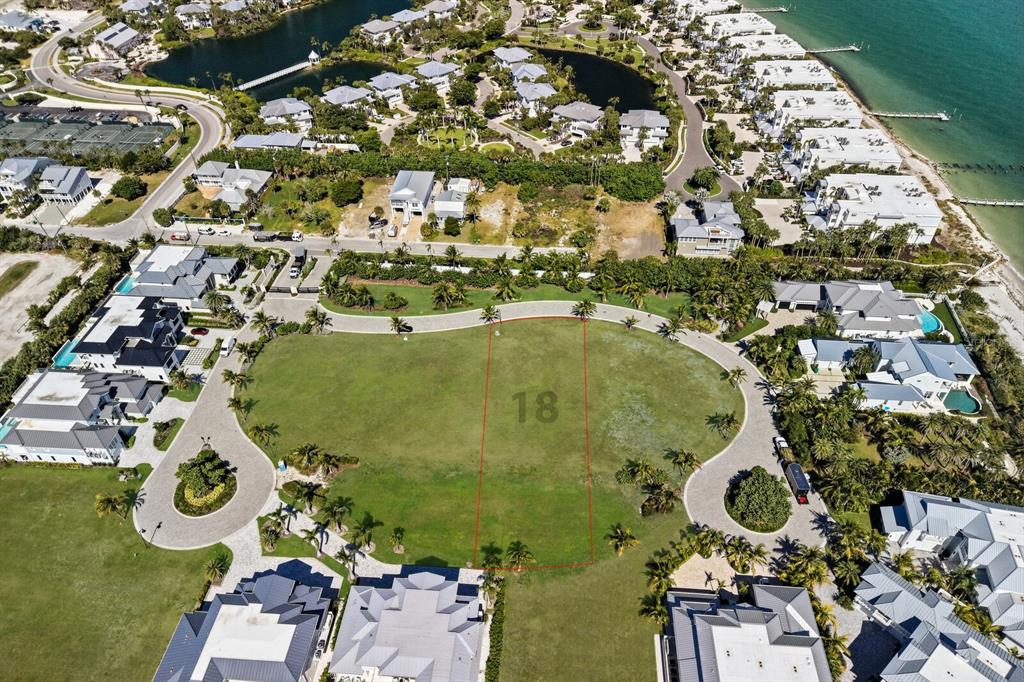 An aerial view shows a vacant, rectangular residential lot marked with the number 18 — 869 HILL TIDE LANE, BOCA GRANDE, FL