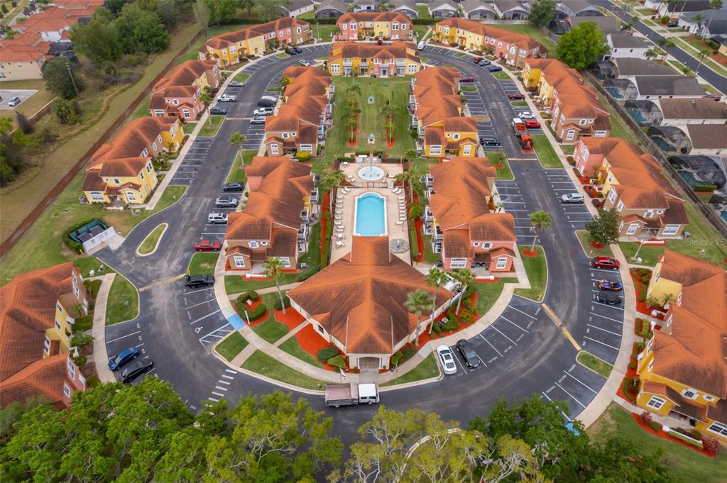 An aerial view shows a residential complex with multiple buildings, a central pool, and parking — 979 PARK TERRACE CIRCLE, KISSIMMEE, FL