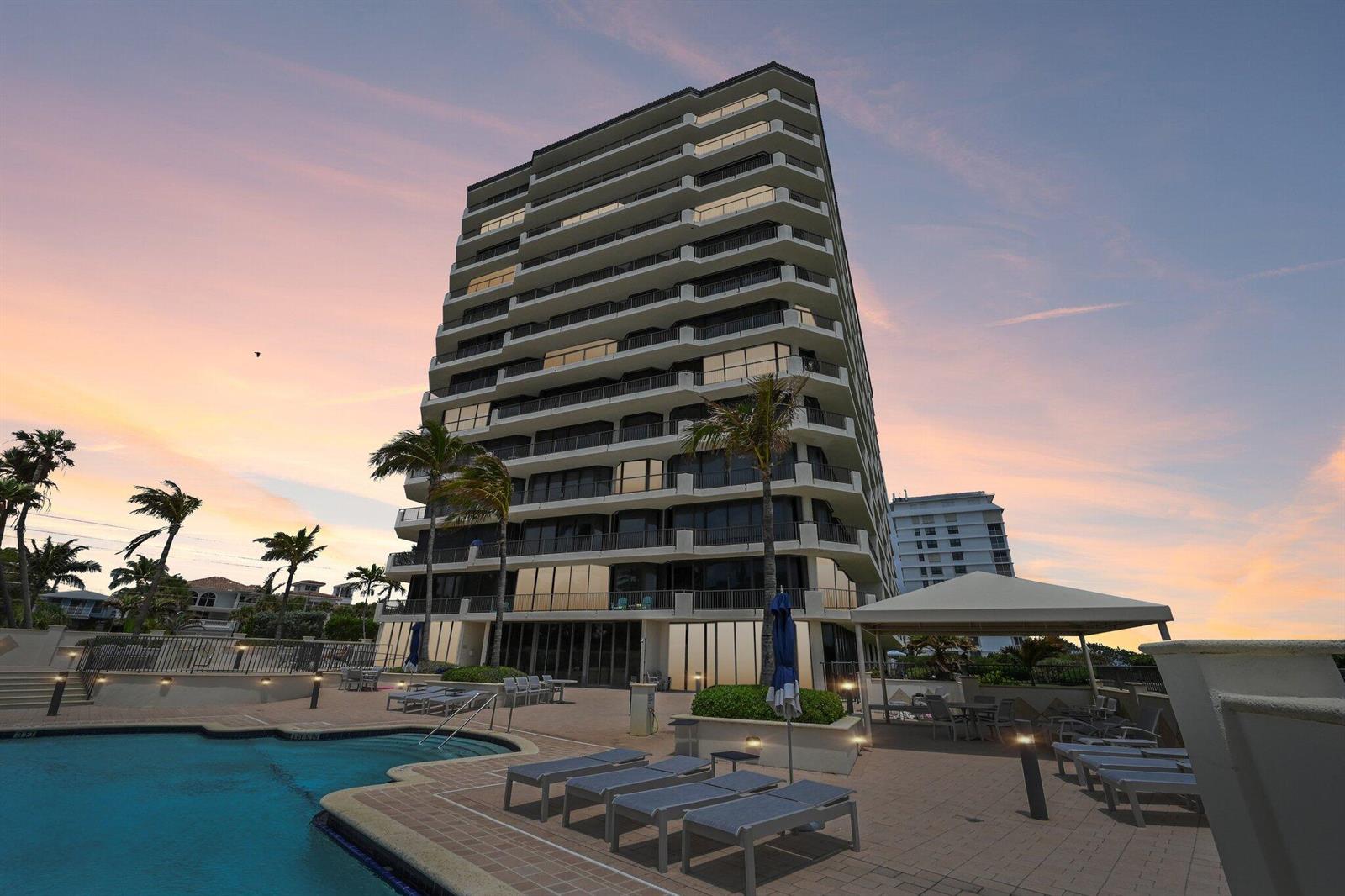 A tall residential building stands beside a swimming pool at sunset — 800 Ocean Drive # 1105, Juno Beach FL 33408, JUNO BEACH, FL